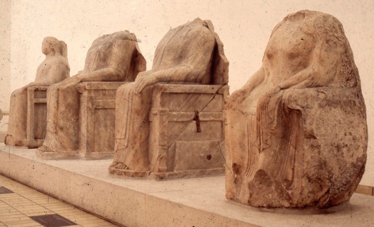 Statues of 4 people- emperors sitting in chairs, 3 headlessrs